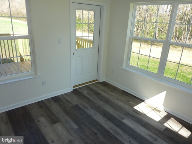 entrance foyer with a healthy amount of sunlight, baseboards, and dark wood finished floors