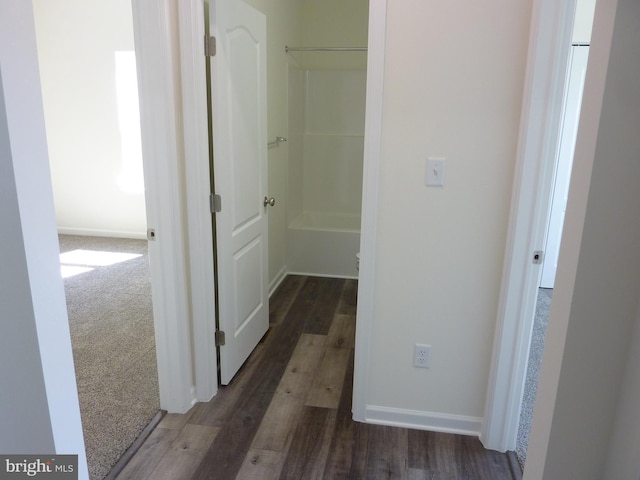 hall featuring wood finished floors and baseboards