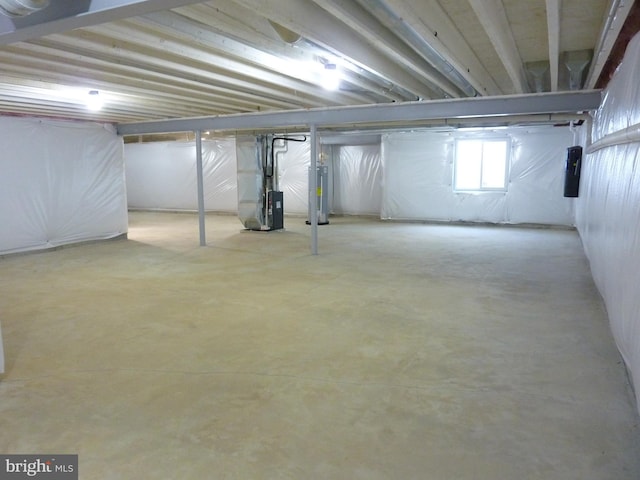 basement featuring water heater and heating unit