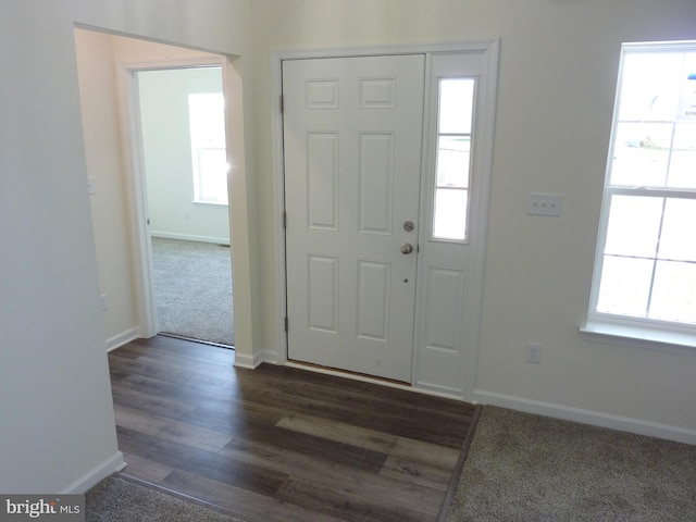 entryway featuring dark wood-style flooring and baseboards