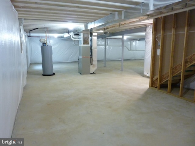 unfinished below grade area featuring water heater and heating unit