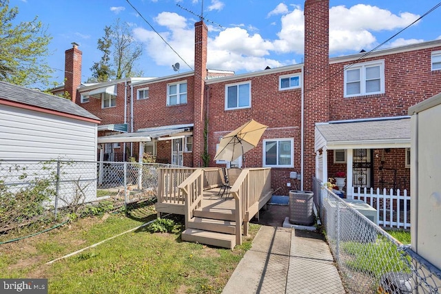 1823 Swansea Rd, Baltimore, MD 21239 - back of house with a fenced backyard, a yard, cooling unit, brick siding, and a deck