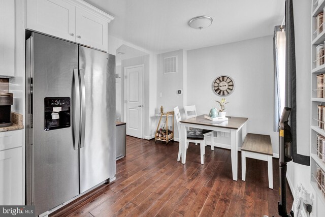1823 Swansea Rd, Baltimore, MD 21239 - kitchen featuring white cabinets, dark wood-style floors, light stone counters, visible vents, and stainless steel refrigerator with ice dispenser