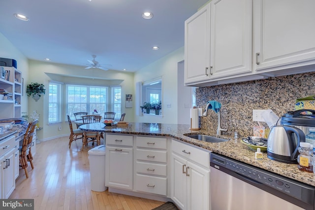 10 Cavendish Ct, Rehoboth Beach, DE 19971 - kitchen featuring dishwasher, a ceiling fan, a sink, white cabinetry, and tasteful backsplash