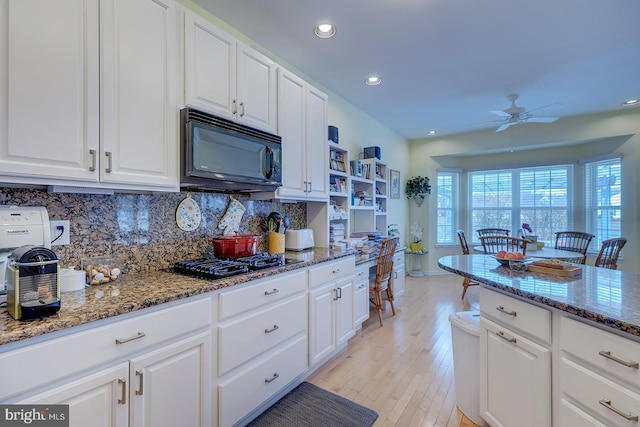 10 Cavendish Ct, Rehoboth Beach, DE 19971 - kitchen with black appliances, a ceiling fan, tasteful backsplash, light wood-style floors, and white cabinets