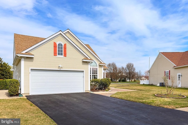10 Cavendish Ct, Rehoboth Beach, DE 19971 - view of front of house featuring asphalt driveway, a garage, a front lawn, central AC, and a shingled roof