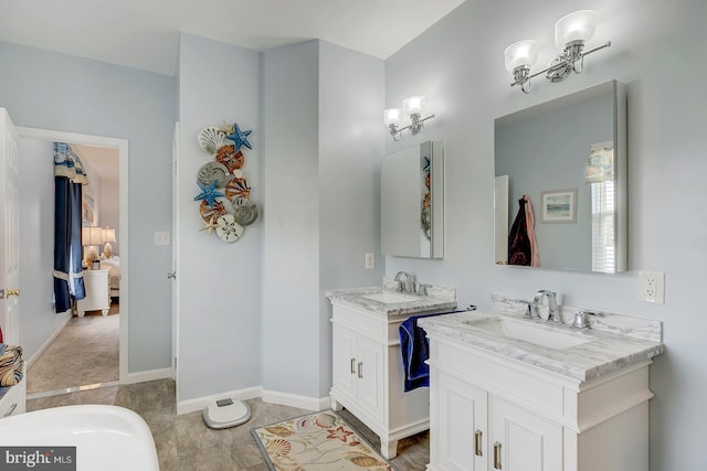 10 Cavendish Ct, Rehoboth Beach, DE 19971 - bathroom featuring two vanities, ensuite bath, and baseboards