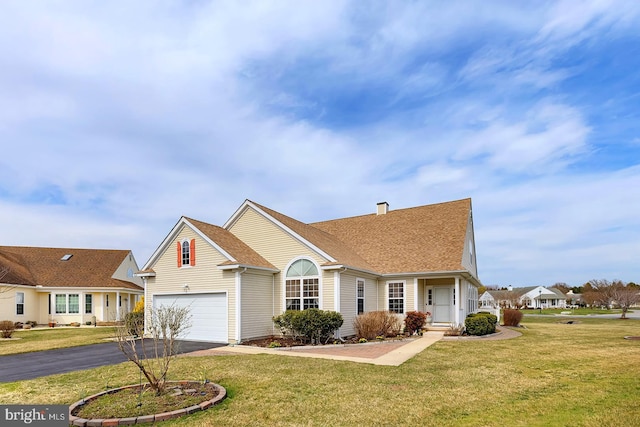 10 Cavendish Ct, Rehoboth Beach, DE 19971 - traditional home with asphalt driveway, a front yard, and a shingled roof