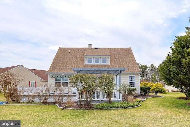 10 Cavendish Ct, Rehoboth Beach, DE 19971 - back of property with a lawn, a chimney, roof with shingles, and a deck