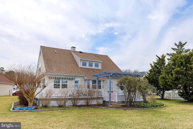10 Cavendish Ct, Rehoboth Beach, DE 19971 - view of front facade featuring a pergola, a wooden deck, a front lawn, a shingled roof, and a chimney