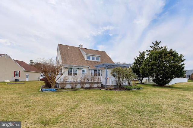 10 Cavendish Ct, Rehoboth Beach, DE 19971 - back of property with a pergola, a yard, and a chimney