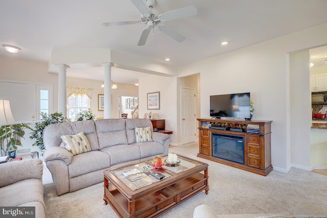 10 Cavendish Ct, Rehoboth Beach, DE 19971 - living area featuring light colored carpet, ornate columns, ceiling fan, recessed lighting, and a glass covered fireplace
