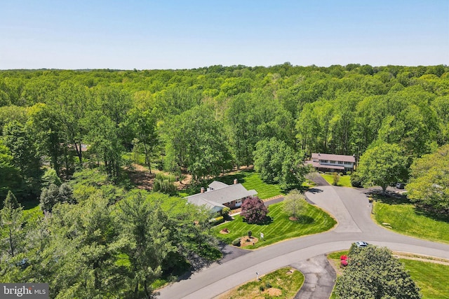 birds eye view of property with a view of trees