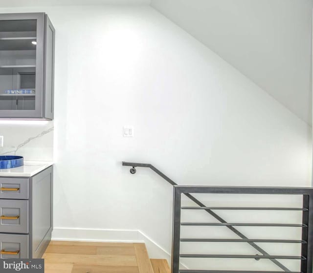stairs with baseboards and wood finished floors