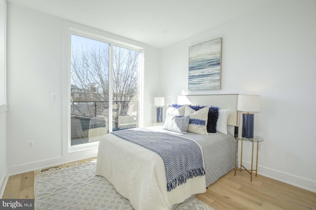 bedroom with baseboards and wood finished floors