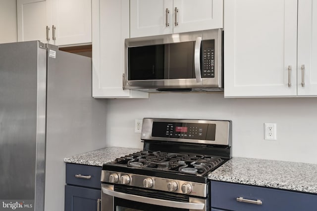 kitchen featuring white cabinetry, blue cabinets, and stainless steel appliances