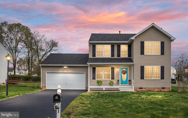 traditional-style house with driveway, crawl space, a front lawn, and an attached garage