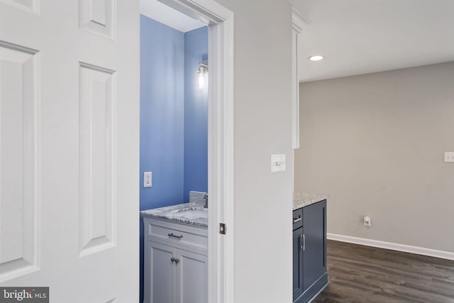 interior space featuring baseboards, recessed lighting, and dark wood-type flooring