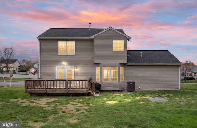 back of house with a wooden deck, central AC, a lawn, a shingled roof, and french doors