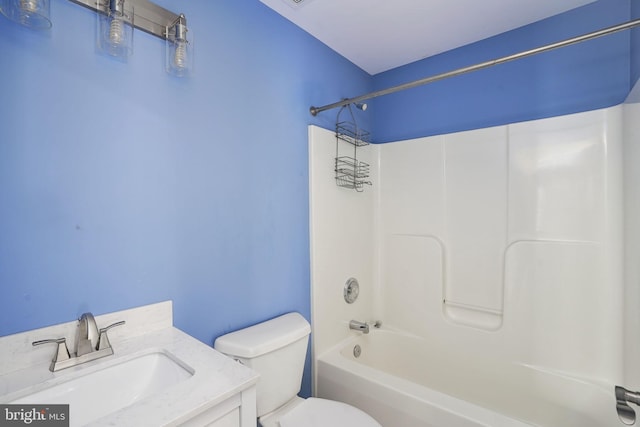 full bath featuring tub / shower combination, toilet, and vanity