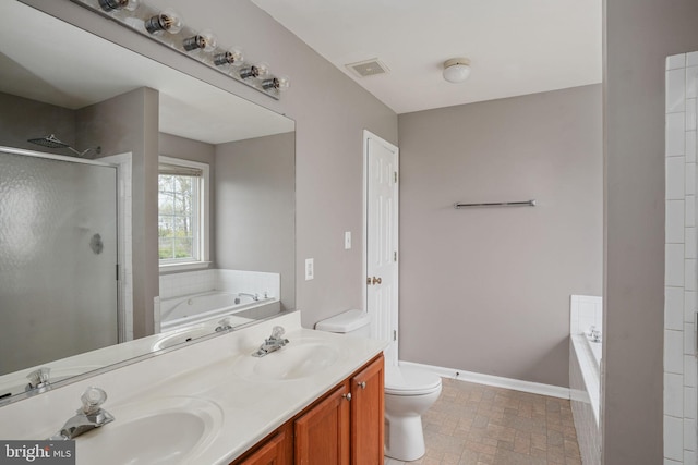 bathroom featuring toilet, a sink, double vanity, and a shower stall
