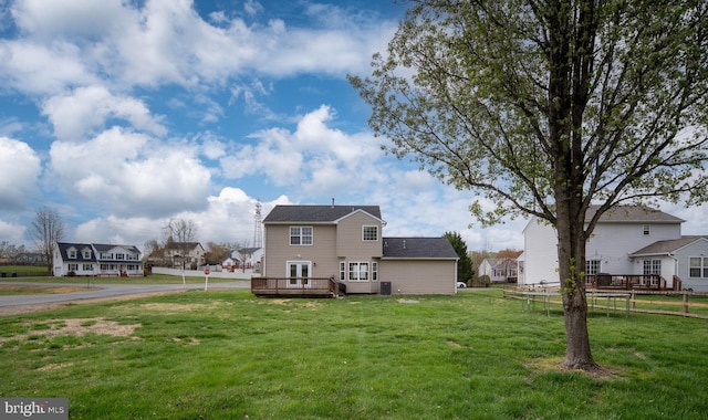back of house with a yard and a deck