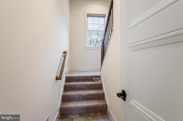 stairway featuring baseboards