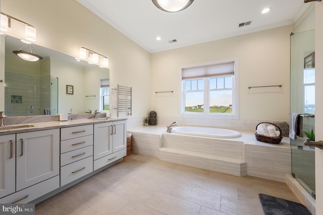 bathroom with a garden tub, visible vents, a sink, and a stall shower