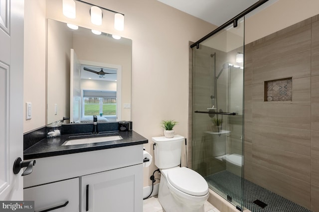 full bath featuring vanity, toilet, a stall shower, and ceiling fan