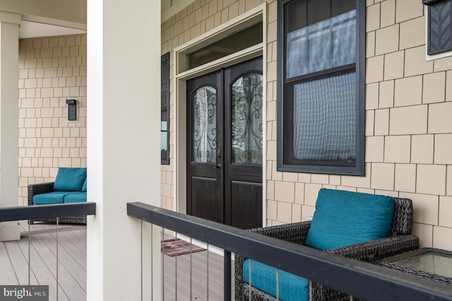 entrance to property featuring french doors and a porch