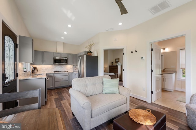 living area featuring recessed lighting, visible vents, a ceiling fan, baseboards, and dark wood-style flooring