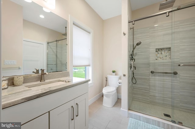 bathroom featuring tile patterned floors, toilet, baseboards, a shower stall, and vanity