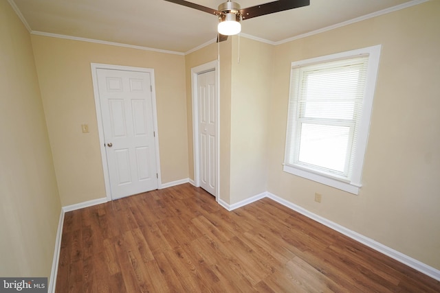 404 Sheldon Ave, Fruitland, MD 21826 - unfurnished bedroom with crown molding, a closet, wood finished floors, baseboards, and a ceiling fan