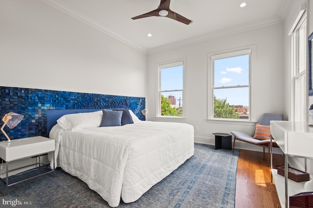 bedroom with recessed lighting, ornamental molding, baseboards, and wood finished floors