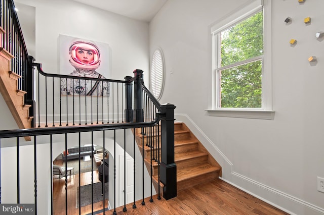 stairs featuring baseboards and wood finished floors