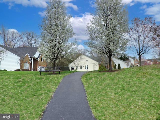 1221 Whetstone Dr, Arnold, MD 21012 - view of side of property with brick siding, driveway, an attached garage, and a lawn