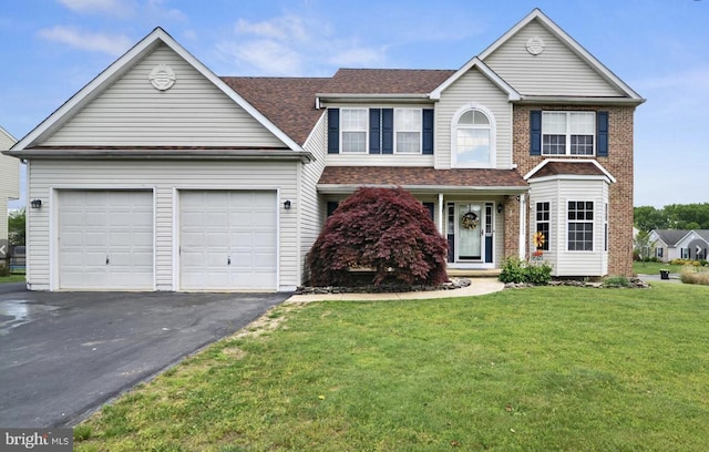 25 Mica St, Townsend, DE 19734 - traditional home with brick siding, an attached garage, a front lawn, and aphalt driveway