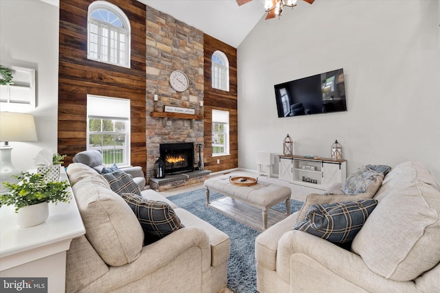 25 Mica St, Townsend, DE 19734 - living area with high vaulted ceiling, ceiling fan, wooden walls, and a fireplace