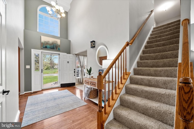 25 Mica St, Townsend, DE 19734 - entryway with baseboards, a notable chandelier, stairway, a towering ceiling, and wood finished floors