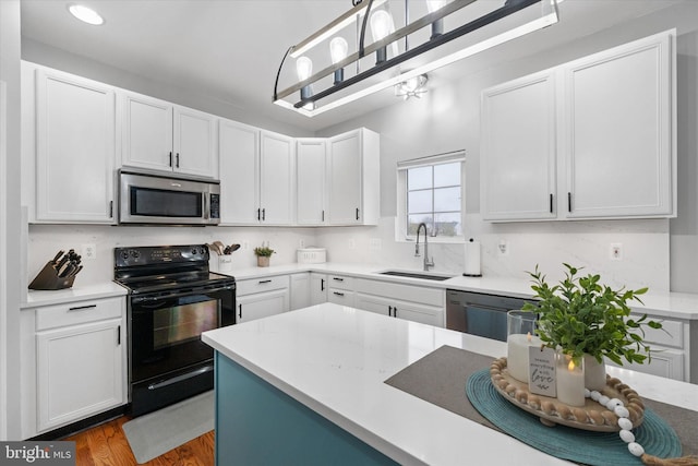 25 Mica St, Townsend, DE 19734 - kitchen with white cabinetry, stainless steel microwave, a sink, dishwasher, and black electric range oven