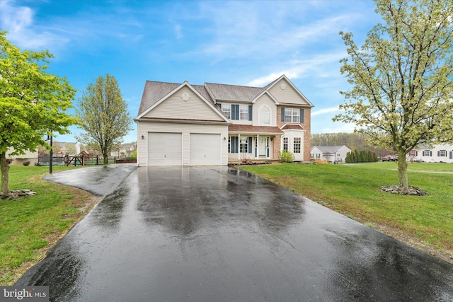 25 Mica St, Townsend, DE 19734 - traditional-style house featuring an attached garage, driveway, a front yard, and fence
