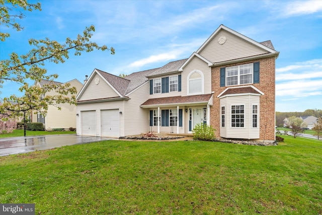 25 Mica St, Townsend, DE 19734 - view of front of property with a garage, a front yard, brick siding, and driveway
