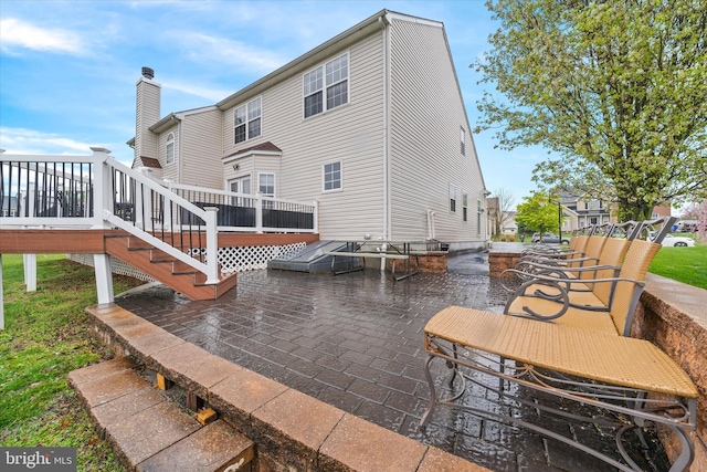 25 Mica St, Townsend, DE 19734 - rear view of property with a chimney, a wooden deck, and a patio area