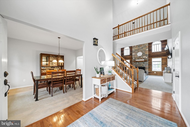 25 Mica St, Townsend, DE 19734 - foyer entrance with a stone fireplace, a high ceiling, wood finished floors, stairs, and baseboards