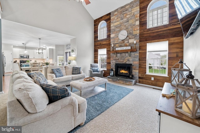 25 Mica St, Townsend, DE 19734 - living room featuring high vaulted ceiling, wooden walls, carpet flooring, and plenty of natural light