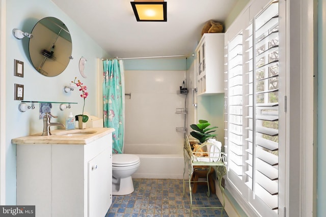bathroom with toilet, vanity, and shower / bath combo with shower curtain