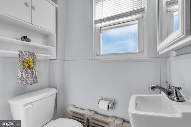 half bath with toilet and a sink