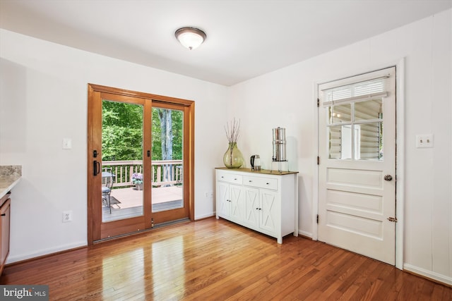 doorway to outside featuring light wood-style floors and baseboards