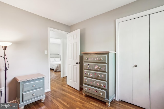 bedroom featuring baseboards, a closet, and wood finished floors