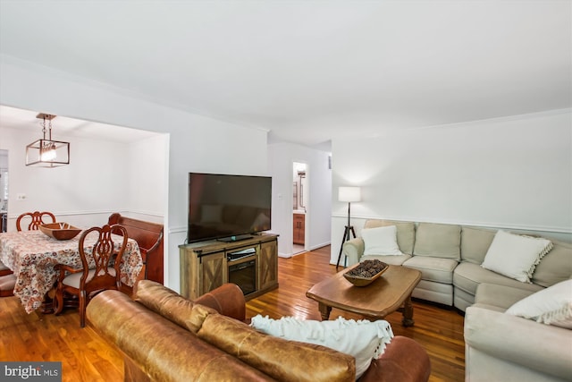 living room featuring crown molding and wood finished floors
